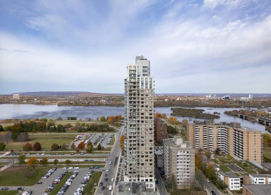 an aerial view of a tall skyscraper next to a river