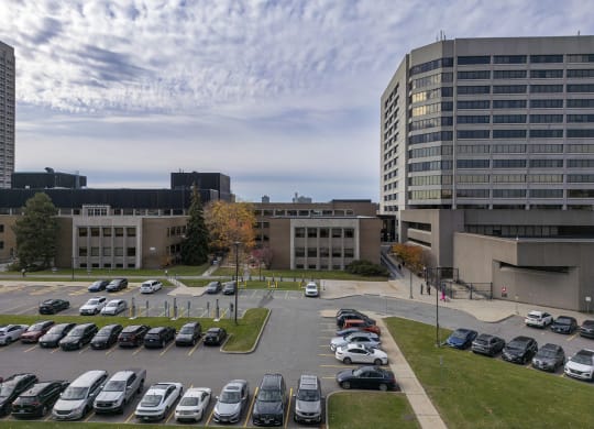 a parking lot in front of a building with cars parked