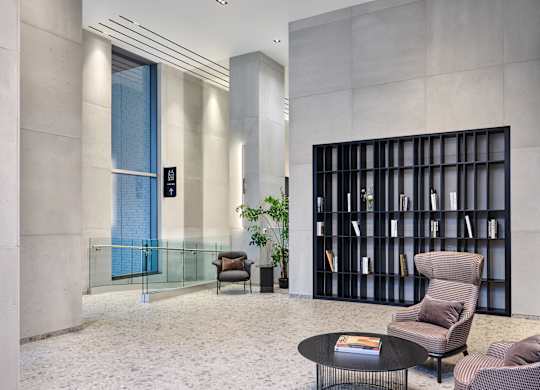 A modern lobby with bookshelf.