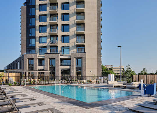 A large building with a pool in front of it.