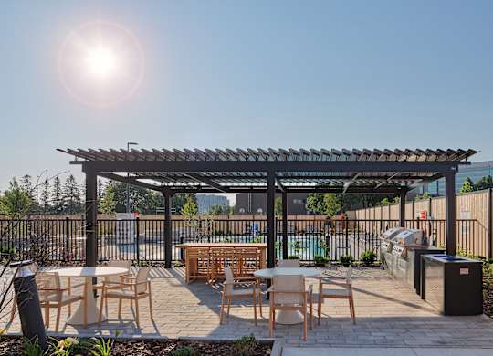 A sunny day at an outdoor patio with tables and chairs.