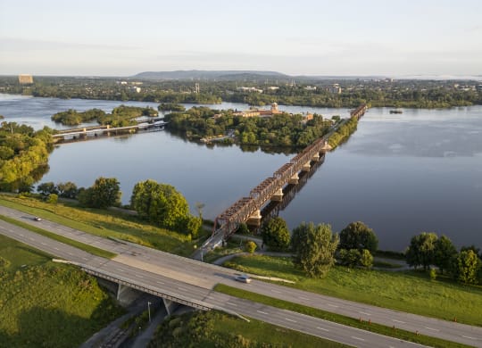 an aerial view of a bridge over a body of water and a highway