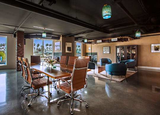 A conference room with a long table and chairs.
