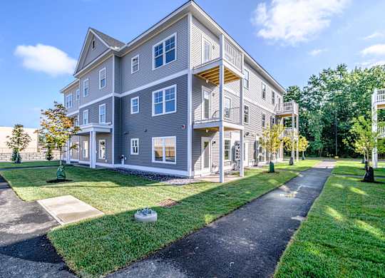 Modern apartment building exterior with balconies at Windham Village Apartments, Windham, ME
