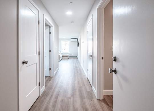 Bright hallway with wood style flooring at Windham Village Apartments, Windham, 04062