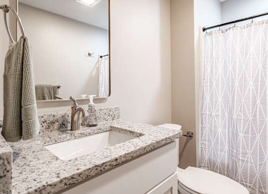 Bathroom with granite countertop and modern fixtures at Windham Village Apartments, Windham