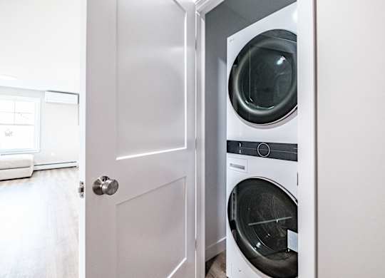 Stacked washer and dryer in laundry closet at Windham Village Apartments, Maine