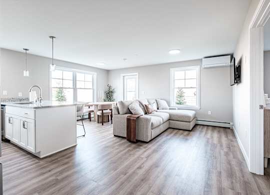 Open concept living area with modern kitchen at Windham Village Apartments, Windham, ME 04062