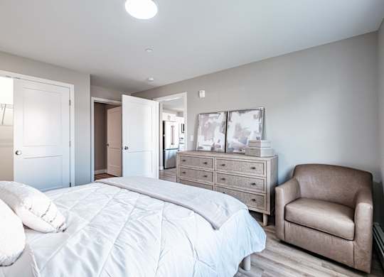 Bedroom with wood style flooring and neutral decor at Windham Village Apartments, Windham, ME