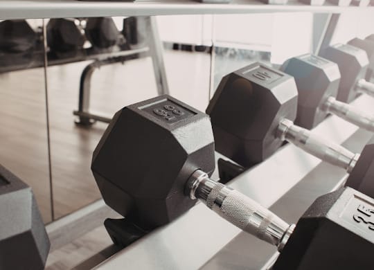 Fitness center with dumbbell rack and equipment at Windham Village Apartments, Windham