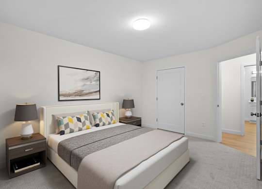 A bedroom with a bed, nightstands, and a painting on the wall.