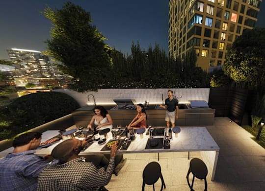 a group of people sitting around a table on a rooftop terrace at night at Chateau on Wells, Chicago