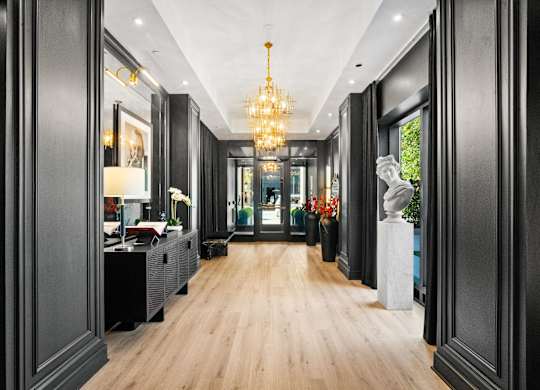 A long hallway with a chandelier hanging from the ceiling at Chateau on Wells, Illinois, 60654