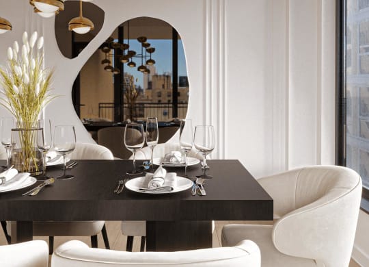 a dining room with white chairs and a black table at Chateau on Wells, Chicago, IL