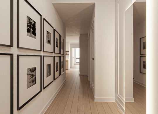 a hallway with black and white photos on the wall and wooden floors at Chateau on Wells, Chicago, IL
