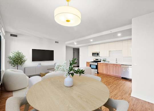 A modern dining room with a wooden table and chairs at Chateau on Wells, Chicago, 60654