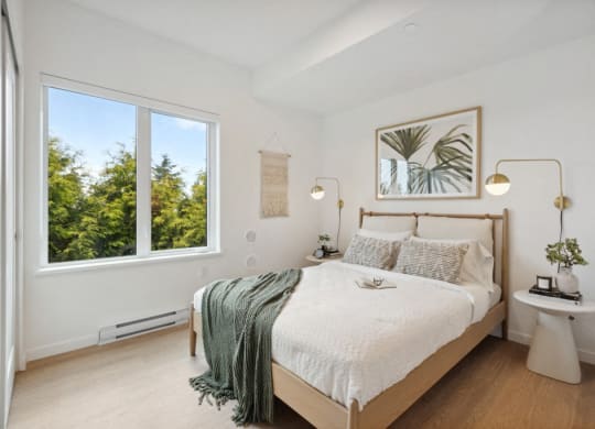 a bedroom with a bed and a large window