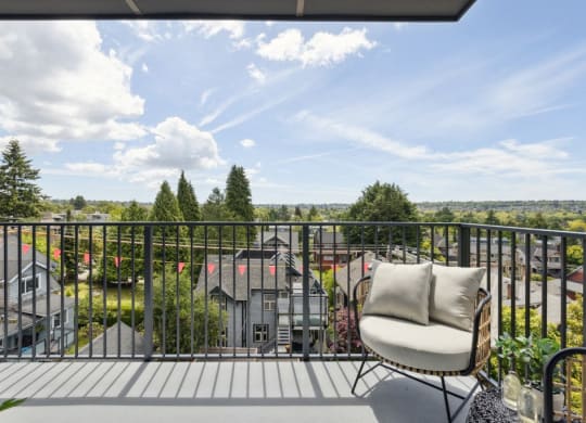 a balcony with a chair and a view of houses
