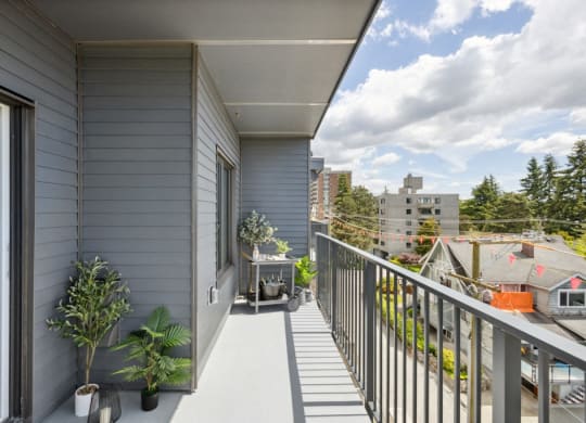 a balcony with a view of a city and a house