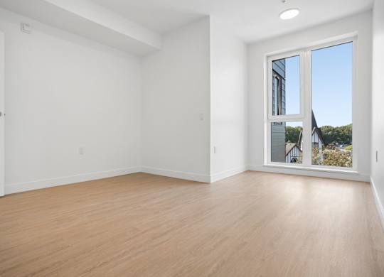 A large empty room with a sliding glass door.