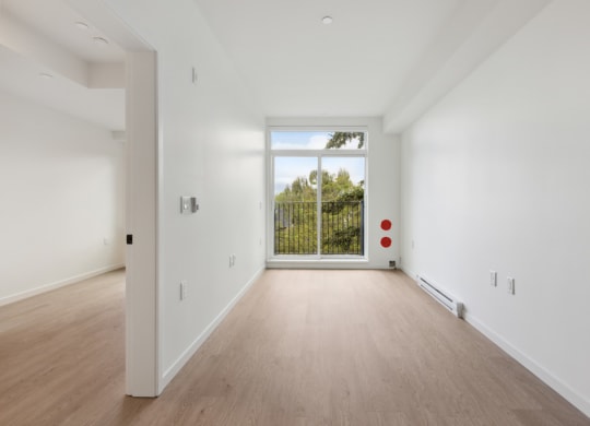 a living room with a large window and white walls