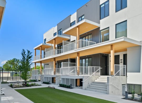 a modern home with a lawn in front of it