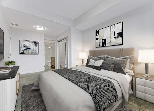 A bedroom with a large bed and a painting on the wall.