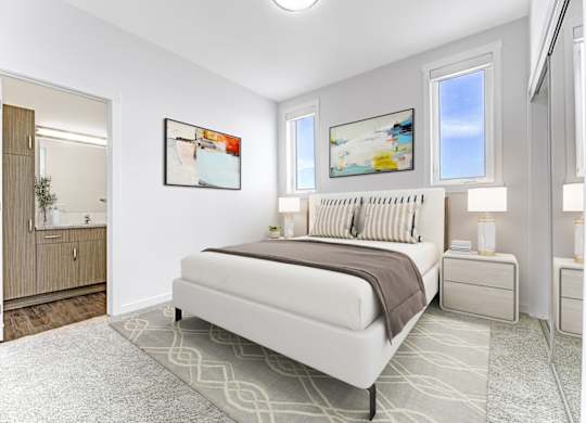 A bedroom with a large bed, two nightstands, and a painting on the wall.
