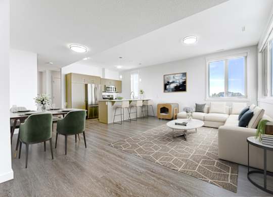 A modern living room with a dining area and a kitchen in the background.
