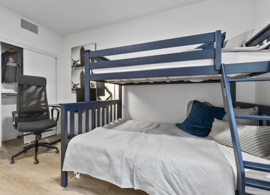 a bedroom with a bunk bed and a desk