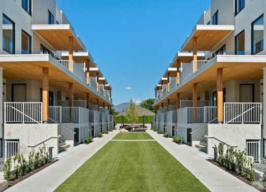 a grassy area in the middle of a row of apartment buildings