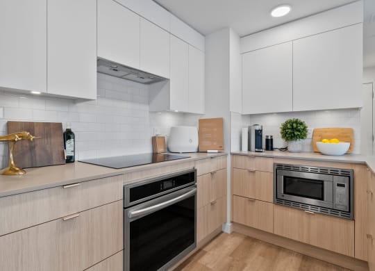 a kitchen with white cabinets and a wooden floor