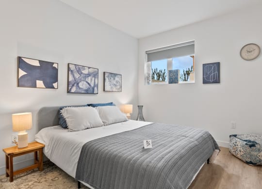 a bedroom with a bed and a window