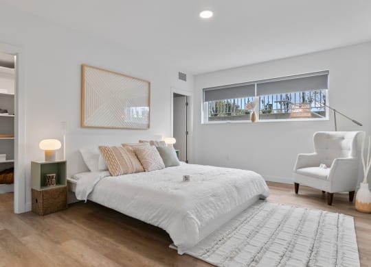 a bedroom with a bed and a chair