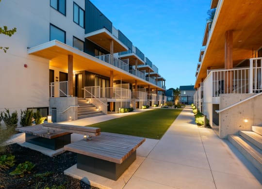 an apartment building with a lot of stairs and green grass