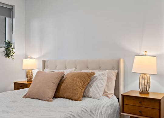 a bedroom with a bed and two night stands with lamps
