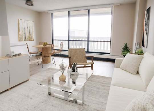 a living room with a white couch and a glass table