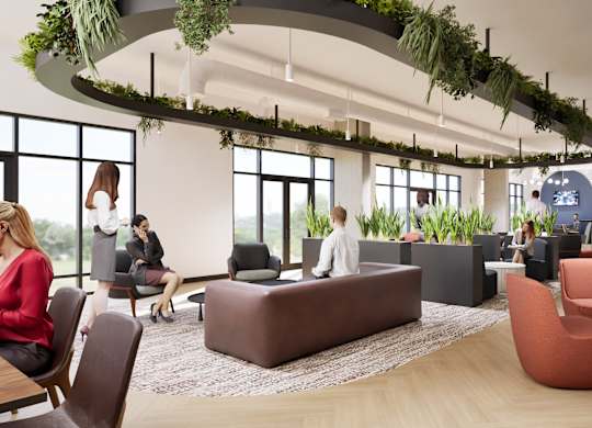 A modern office space with people working and sitting around.