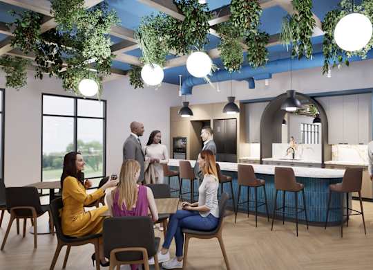 A group of people are gathered in a modern, open-plan office space.