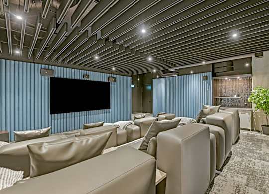 A modern home theater with a large screen and comfortable seating.