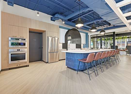 A modern kitchen with a blue counter and stainless steel appliances.