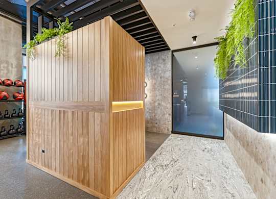 A wooden structure with a light on the side is in the middle of a room.