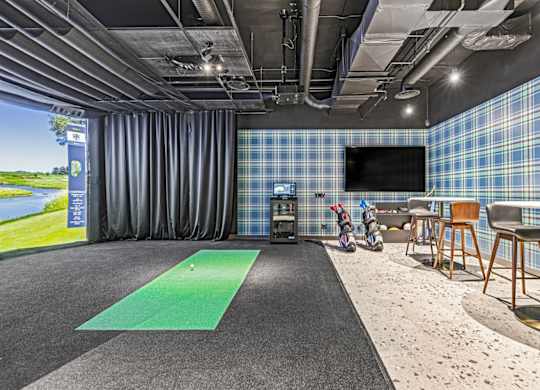 A room with a green mat on the floor and a blue plaid wallpaper.