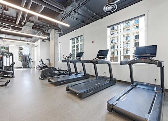 A gym with treadmills and other exercise equipment.