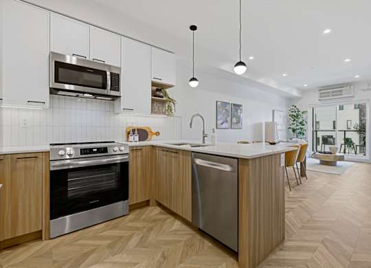 A modern kitchen with wooden cabinets and a large island.