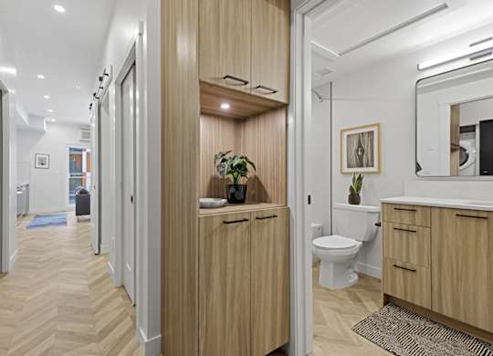 A bathroom with a toilet, sink, and mirror.