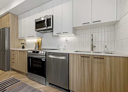A modern kitchen with wooden cabinets and stainless steel appliances.
