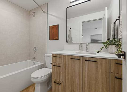 A bathroom with a white toilet, a white sink, and a white bathtub.