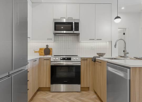 A modern kitchen with stainless steel appliances and wooden cabinets.
