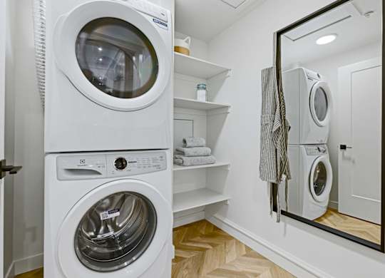 A white washing machine and dryer in a small laundry room.